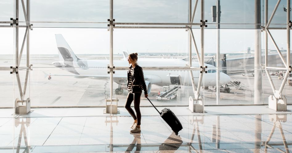 women traveling in airport with luggage